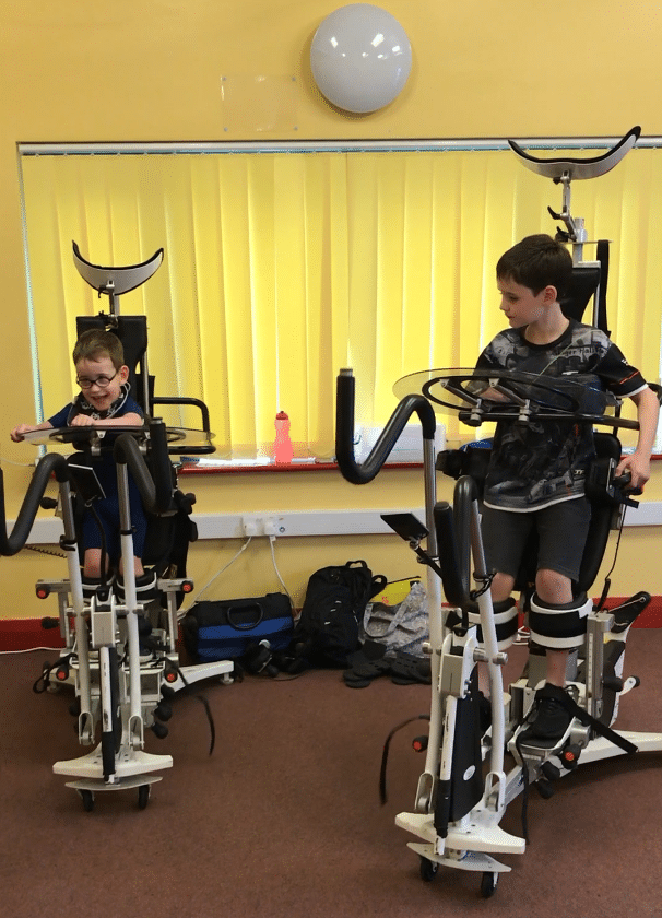 Two young children using specialist assisted walkers at the Gympanzees Pop Up
