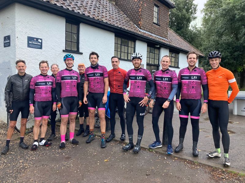 A group of men in pink cycling jerseys