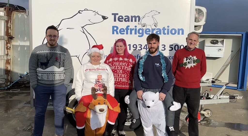 A group of people stood outside in Christmas Jumpers