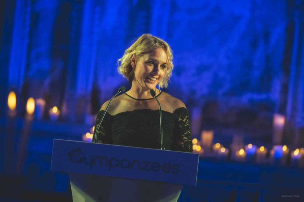 A blonde woman stood at a podium