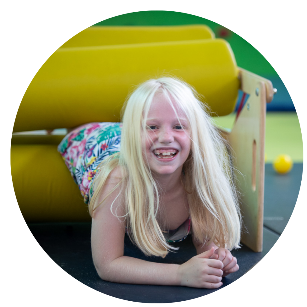 A girl squeezing through a squeeze machine