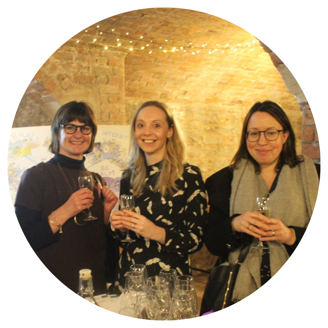 A group of women stood drinking wine