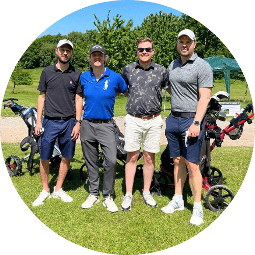 Four men are posing for picture at the golf court