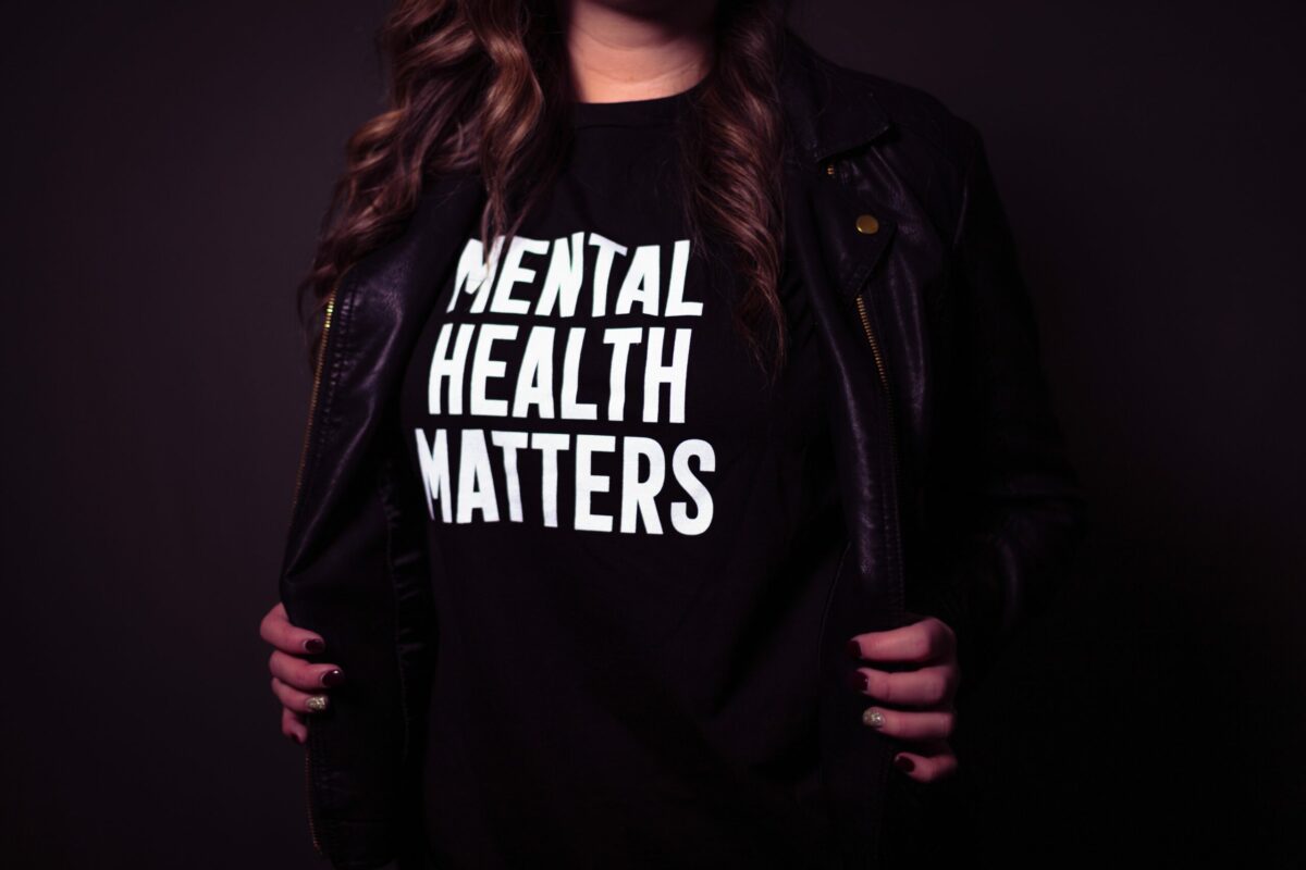 A woman with black jumper saying 'Mental Health Matters'