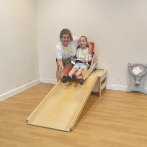 A woman and her child trying scoot ramp at Gympanzees Pop Up