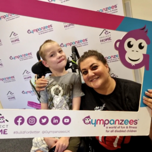 A woman and her child taking a selfie with Gympanzees selfie frame