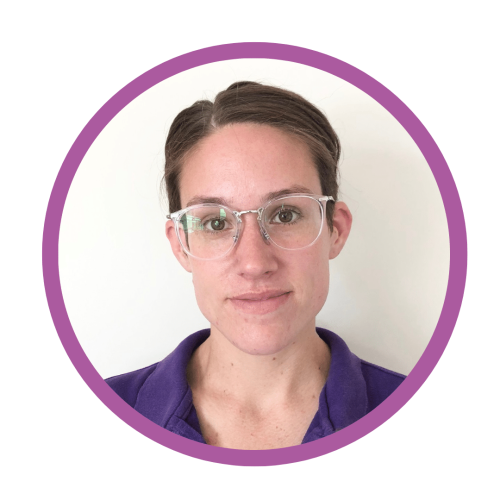 Julia's profile photo. She is wearing a purple polo top and glasses